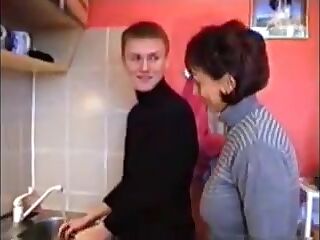 Russian mom Amalia with her boy in kitchen